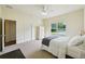 Bright bedroom with a ceiling fan, a bed, and a large white armoire offering ample storage space at 25238 Bunting Cir, Land O Lakes, FL 34639