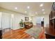 Relaxing den featuring recessed lighting, hardwood flooring, and a comfortable recliner with a tranquil ambiance at 25238 Bunting Cir, Land O Lakes, FL 34639