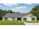 Charming home with a well-manicured lawn, showcasing its inviting curb appeal and a freshly painted exterior at 25238 Bunting Cir, Land O Lakes, FL 34639