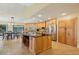 This spacious kitchen features wood cabinets, granite countertops, and a large center island with bar seating at 25238 Bunting Cir, Land O Lakes, FL 34639