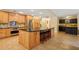 Bright kitchen featuring an island with seating, stainless steel appliances, and ample cabinet space at 25238 Bunting Cir, Land O Lakes, FL 34639