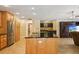 Bright kitchen featuring an island with seating, stainless steel appliances, and ample cabinet space at 25238 Bunting Cir, Land O Lakes, FL 34639