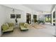 This screened lanai has a comfortable lounge area and outdoor picnic table for relaxation and dining at 25238 Bunting Cir, Land O Lakes, FL 34639