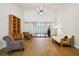 Open-concept living space with a chandelier, a high ceiling, and a light wood floor leading to the front door at 25238 Bunting Cir, Land O Lakes, FL 34639