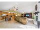 Expansive living area with tile floors, a stone fireplace, vaulted ceilings, and an open layout to the kitchen at 25238 Bunting Cir, Land O Lakes, FL 34639