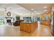Open concept living area with stone fireplace and kitchen with breakfast bar, perfect for entertaining at 25238 Bunting Cir, Land O Lakes, FL 34639