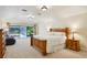 Spacious main bedroom with large windows, neutral carpet, and a king-sized bed at 25238 Bunting Cir, Land O Lakes, FL 34639