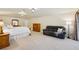 Spacious main bedroom featuring a king-sized bed, dresser, and sitting area for relaxing at 25238 Bunting Cir, Land O Lakes, FL 34639