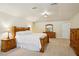 Spacious main bedroom with a king-sized bed, dresser, and large windows allowing natural light at 25238 Bunting Cir, Land O Lakes, FL 34639