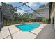 This screened in pool features a spa and spacious patio for relaxation and entertainment by the poolside at 25238 Bunting Cir, Land O Lakes, FL 34639