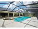 This backyard has a screened pool with an attached spa, surrounded by a patio and views of the yard at 25238 Bunting Cir, Land O Lakes, FL 34639