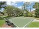 Enjoy a game on this outdoor basketball court surrounded by lush greenery and complete with a seating bench at 27209 Firebush Dr, Wesley Chapel, FL 33544