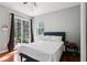 Bedroom featuring wood floors and a sliding glass door leading to the outside at 27209 Firebush Dr, Wesley Chapel, FL 33544