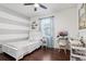 Bedroom featuring wood floors, a ceiling fan, large window, and modern decor at 27209 Firebush Dr, Wesley Chapel, FL 33544