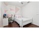 Bright bedroom featuring colorful geometric wall art and wood flooring at 27209 Firebush Dr, Wesley Chapel, FL 33544