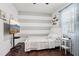 Bedroom featuring wood floors, a ceiling fan, large window, and modern decor at 27209 Firebush Dr, Wesley Chapel, FL 33544