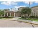 Exterior of the community clubhouse featuring well-maintained landscaping and a welcoming entrance at 27209 Firebush Dr, Wesley Chapel, FL 33544