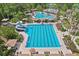 Aerial view of a large community pool with swimming lanes, waterslides, and plenty of lounge seating at 27209 Firebush Dr, Wesley Chapel, FL 33544