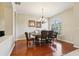 Elegant dining room featuring a wood table, chandelier lighting, and ample natural light at 27209 Firebush Dr, Wesley Chapel, FL 33544