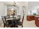 Charming dining area with wooden table, chairs, and decorative chandelier at 27209 Firebush Dr, Wesley Chapel, FL 33544