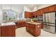 Modern kitchen with granite countertops, center island, stainless steel appliances, and ample cabinet space at 27209 Firebush Dr, Wesley Chapel, FL 33544