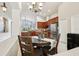 Bright kitchen and breakfast nook featuring wooden cabinets, granite countertops, and stainless steel appliances at 27209 Firebush Dr, Wesley Chapel, FL 33544