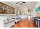 Spacious living room with wood floors, a decorative wall, and plenty of natural light at 27209 Firebush Dr, Wesley Chapel, FL 33544