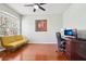 Bright office space with wood floors, a large window, and functional furniture setup at 27209 Firebush Dr, Wesley Chapel, FL 33544