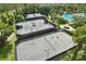 Aerial view showcasing community tennis courts adjacent to a pool and other recreational amenities at 27209 Firebush Dr, Wesley Chapel, FL 33544