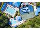 Aerial view features a community pool with a slide and a splash pad surrounded by lush landscape at 28390 Openfield Loop, Wesley Chapel, FL 33543