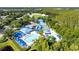 Aerial view shows community pool area, tennis courts, clubhouse, and recreational facilities at 28390 Openfield Loop, Wesley Chapel, FL 33543
