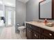 Bathroom with tiled floor, dark wood vanity and a walk in shower at 28390 Openfield Loop, Wesley Chapel, FL 33543