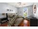 A staged bedroom shows the lovely hardwood floors, pretty decor, and comfortable furnishings at 28390 Openfield Loop, Wesley Chapel, FL 33543