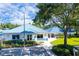 Exterior view of community fitness center features blue roof, fresh landscaping, and ample parking at 28390 Openfield Loop, Wesley Chapel, FL 33543