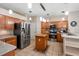 Well-lit kitchen featuring stainless steel appliances, granite countertops, and wood cabinets at 28390 Openfield Loop, Wesley Chapel, FL 33543