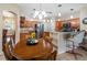 The kitchen has stainless appliances, granite countertops, and wood cabinets and is open to the dining area at 28390 Openfield Loop, Wesley Chapel, FL 33543