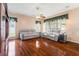 Spacious living room with hardwood floors features dual reclining sofas and large windows at 28390 Openfield Loop, Wesley Chapel, FL 33543