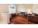 Comfortable living room featuring hardwood floors, large windows, neutral-toned furniture, and ample natural light at 28390 Openfield Loop, Wesley Chapel, FL 33543