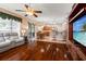 Spacious open floor plan features hardwood floors and a view of the kitchen at 28390 Openfield Loop, Wesley Chapel, FL 33543