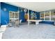 Cozy screened-in porch with pool table and dining seating area, perfect for outdoor enjoyment at 28390 Openfield Loop, Wesley Chapel, FL 33543