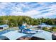 Community waterpark area with multiple slides and play areas, with a basketball court nearby under a cloudy sky at 28390 Openfield Loop, Wesley Chapel, FL 33543