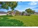 Expansive backyard features a screened-in pool area and a well-maintained lawn, perfect for outdoor entertaining at 2847 Mossy Timber Trl, Valrico, FL 33596