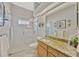 Bathroom featuring walk-in shower, granite vanity, and decorative fixtures at 2847 Mossy Timber Trl, Valrico, FL 33596