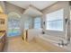 Bright bathroom with large soaking tub and glass enclosed shower at 2847 Mossy Timber Trl, Valrico, FL 33596
