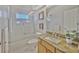 Bright bathroom featuring a tub and shower combination with glass doors, and a granite vanity at 2847 Mossy Timber Trl, Valrico, FL 33596