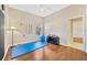 Bedroom with wood floors and a blue exercise mat near a window at 2847 Mossy Timber Trl, Valrico, FL 33596