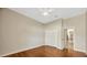 Neutral bedroom with wood floors, closet, and door to hallway at 2847 Mossy Timber Trl, Valrico, FL 33596