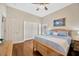 Spacious bedroom with wood floors, ceiling fan, and a large closet at 2847 Mossy Timber Trl, Valrico, FL 33596