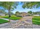 Stunning exterior elevation with mature trees and landscaping at 2847 Mossy Timber Trl, Valrico, FL 33596