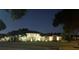 Exterior night view of a home with landscape lighting highlighting its architectural features at 2847 Mossy Timber Trl, Valrico, FL 33596